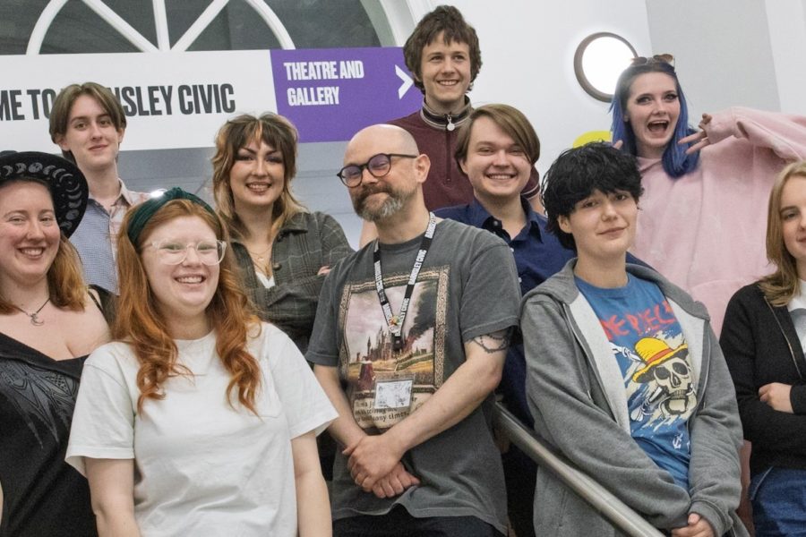 A group of young people stand in the entry of an arts centre