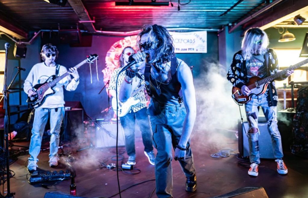 An alternative rock band perform on stage.